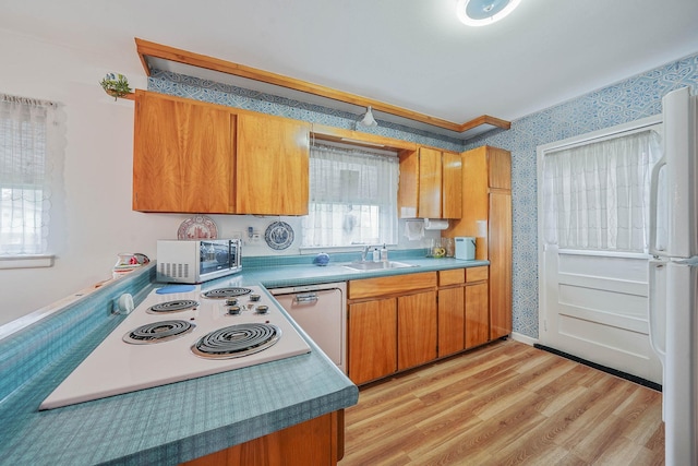 3 Shelter Hill Rd, Plainview, NY 11803 - kitchen featuring stainless steel microwave, wallpapered walls, brown cabinetry, a sink, and light wood finished floors
