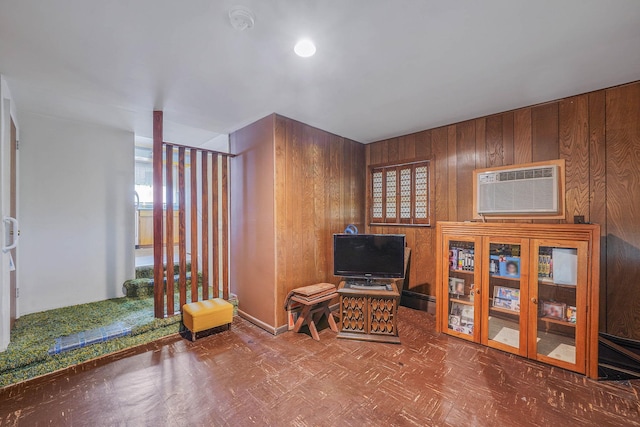 3 Shelter Hill Rd, Plainview, NY 11803 - sitting room featuring tile patterned floors, a wall unit AC, wood walls, and baseboards