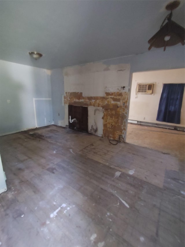 54 Meadowmere Ave, Mastic Beach, NY 11950 - unfurnished living room with a fireplace, wood finished floors, and a wall unit AC