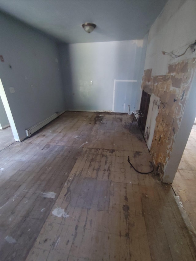 54 Meadowmere Ave, Mastic Beach, NY 11950 - unfurnished living room featuring wood-type flooring, a baseboard heating unit, and a fireplace