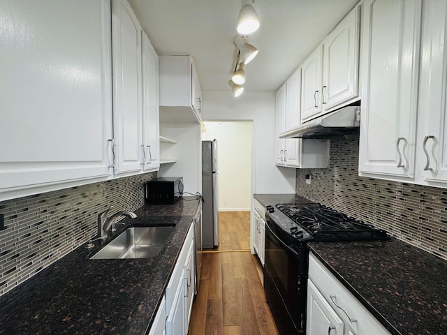 43-10 Kissena Blvd Unit 2B, Flushing, NY 11355 - kitchen with black appliances, under cabinet range hood, a sink, dark wood-style flooring, and decorative backsplash