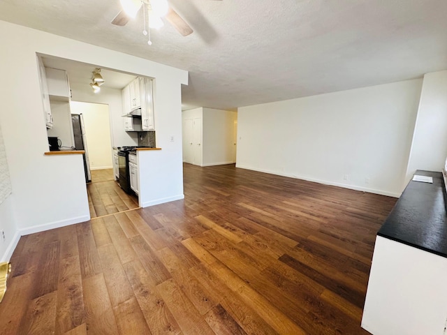 43-10 Kissena Blvd Unit 2B, Flushing, NY 11355 - unfurnished living room featuring ceiling fan, dark wood-type flooring, and baseboards