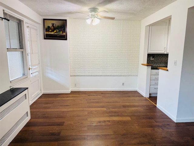 43-10 Kissena Blvd Unit 2B, Flushing, NY 11355 - unfurnished dining area featuring ceiling fan, dark wood-style floors, a textured ceiling, and baseboards