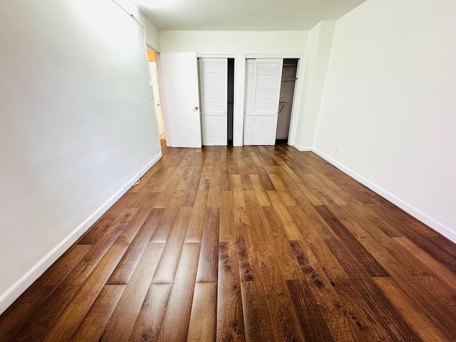 43-10 Kissena Blvd Unit 2B, Flushing, NY 11355 - unfurnished bedroom with two closets, baseboards, and wood finished floors