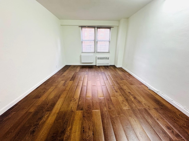 43-10 Kissena Blvd Unit 2B, Flushing, NY 11355 - unfurnished room featuring radiator heating unit, dark wood-type flooring, and baseboards