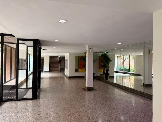 105-37 65th Ave Unit 6E, Forest Hills, NY 11375 - community lobby featuring stairway, recessed lighting, and a wall of windows