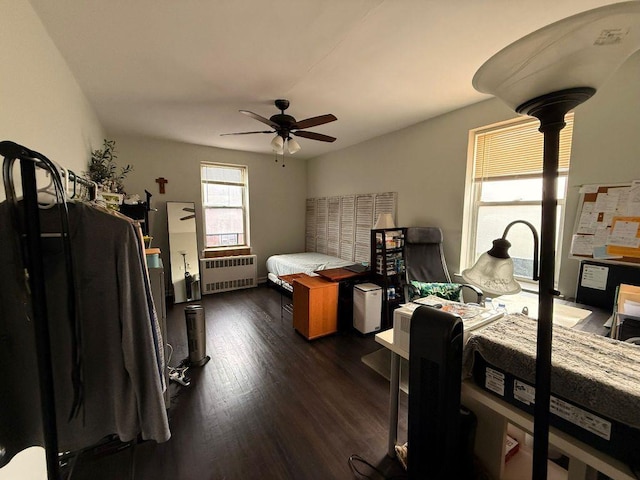 105-37 65th Ave Unit 6E, Forest Hills, NY 11375 - bedroom with radiator heating unit, dark wood-style flooring, and ceiling fan