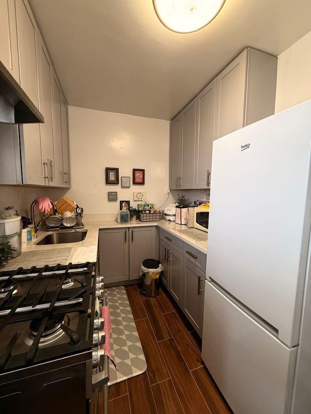 105-37 65th Ave Unit 6E, Forest Hills, NY 11375 - kitchen with white appliances, gray cabinetry, a sink, dark wood finished floors, and light countertops