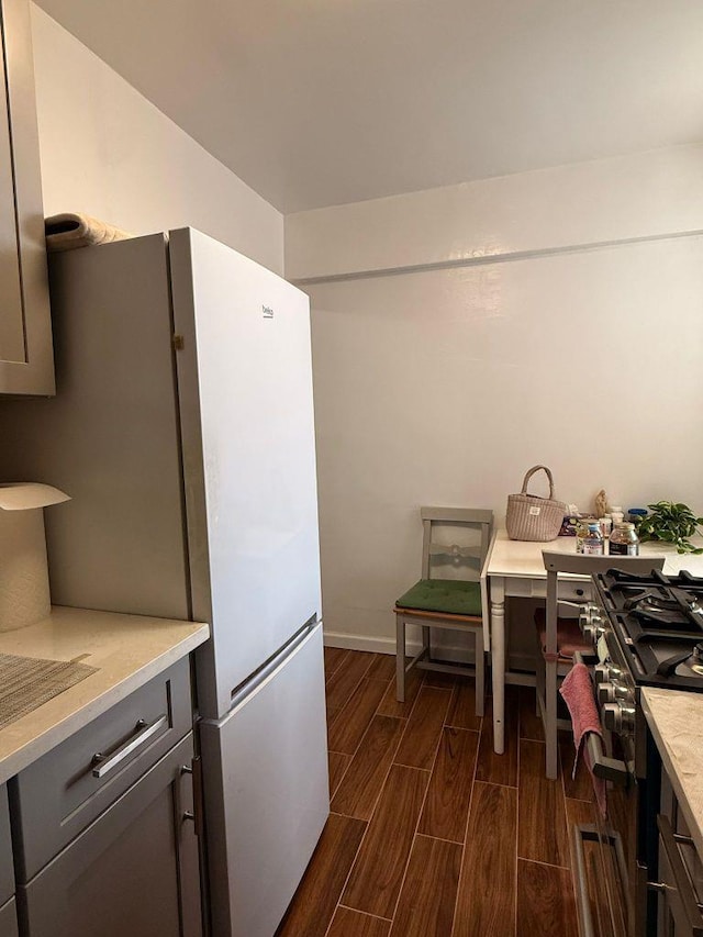 105-37 65th Ave Unit 6E, Forest Hills, NY 11375 - kitchen featuring wood finish floors, light countertops, freestanding refrigerator, baseboards, and gray cabinetry