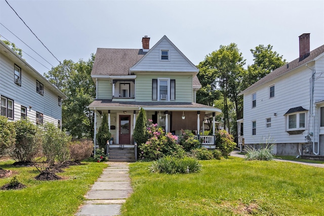 184 Highland Ave, Middletown, NY 10940 - view of front facade with covered porch, a chimney, a front lawn, and roof with shingles