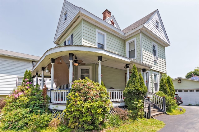 184 Highland Ave, Middletown, NY 10940 - victorian house featuring a porch, ceiling fan, a chimney, and an outbuilding