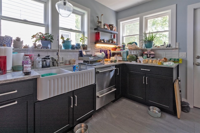 184 Highland Ave, Middletown, NY 10940 - kitchen featuring dark cabinets, decorative backsplash, light countertops, and a sink