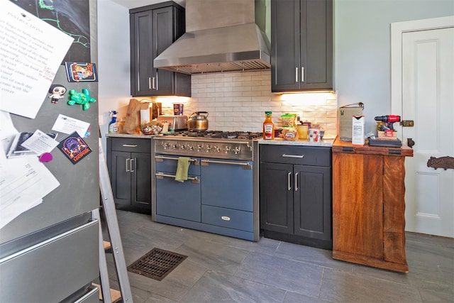 184 Highland Ave, Middletown, NY 10940 - kitchen featuring wall chimney exhaust hood, appliances with stainless steel finishes, tasteful backsplash, and light stone countertops