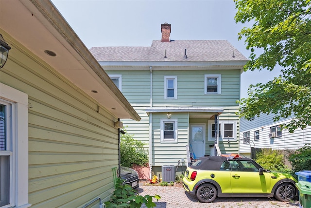 184 Highland Ave, Middletown, NY 10940 - rear view of property with a chimney, central air condition unit, and roof with shingles