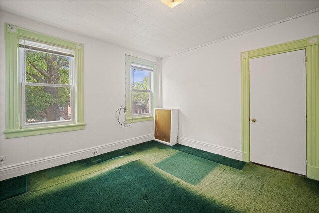 4614 Carpenter Ave, Bronx, NY 10470 - unfurnished room featuring dark carpet, healthy amount of natural light, and baseboards