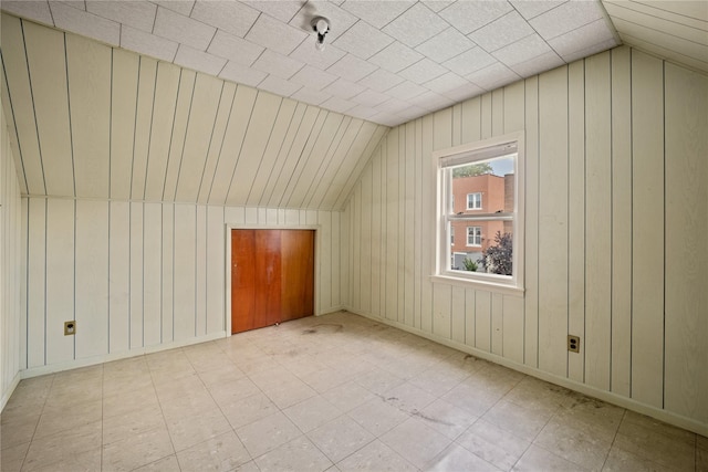 4614 Carpenter Ave, Bronx, NY 10470 - additional living space with lofted ceiling, wood walls, and baseboards