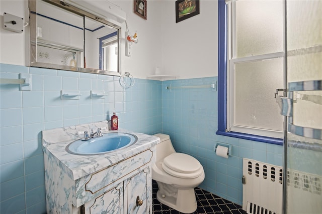 4614 Carpenter Ave, Bronx, NY 10470 - bathroom with tile walls, vanity, toilet, tile patterned flooring, and radiator heating unit