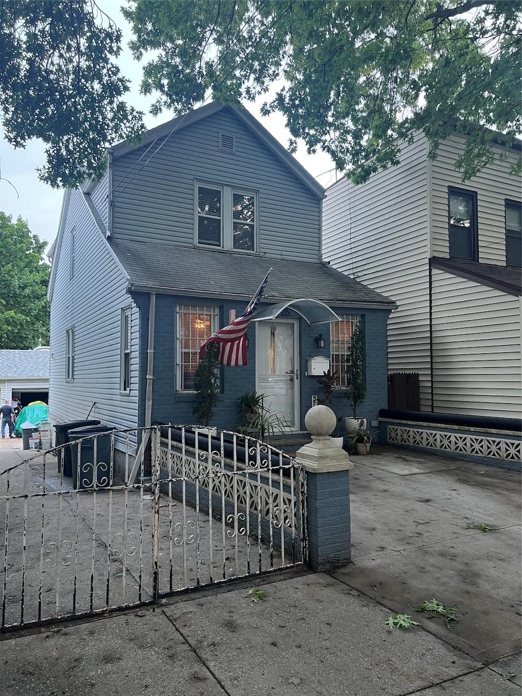 22-26 74th St, East Elmhurst, NY 11370 - view of front of property with a fenced front yard and a shingled roof