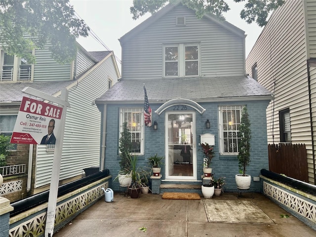 22-26 74th St, East Elmhurst, NY 11370 - view of front of property featuring brick siding, a shingled roof, and entry steps
