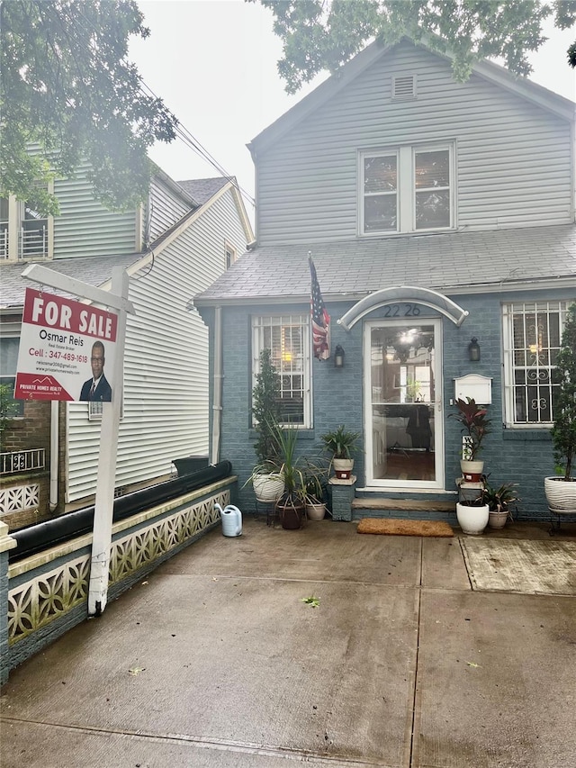 22-26 74th St, East Elmhurst, NY 11370 - view of front facade with brick siding and entry steps