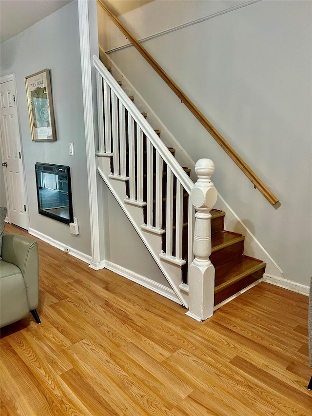 22-26 74th St, East Elmhurst, NY 11370 - staircase featuring wood finished floors and heating unit