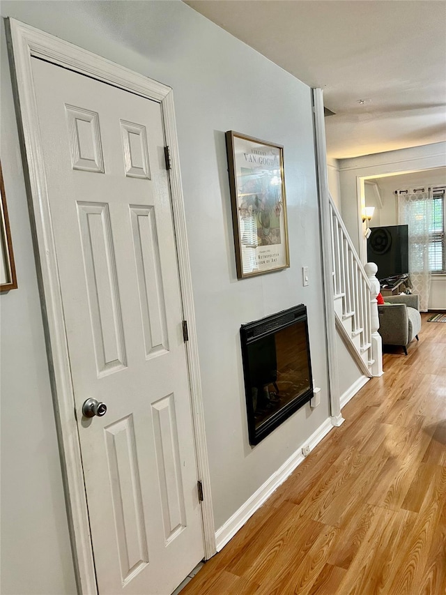 22-26 74th St, East Elmhurst, NY 11370 - corridor with light wood-type flooring and stairway