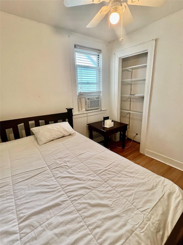 22-26 74th St, East Elmhurst, NY 11370 - bedroom with cooling unit, wood finished floors, ceiling fan, and a closet