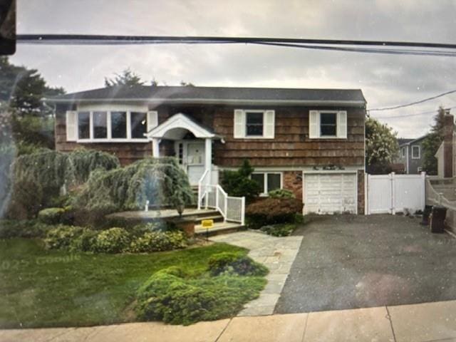 104 Clark Ave, Massapequa, NY 11758 - bi-level home with asphalt driveway and a garage