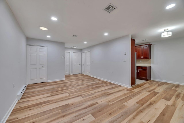 305C Torquay Court, Ridge, NY 11961 - empty room featuring baseboard heating, light wood-style flooring, and recessed lighting