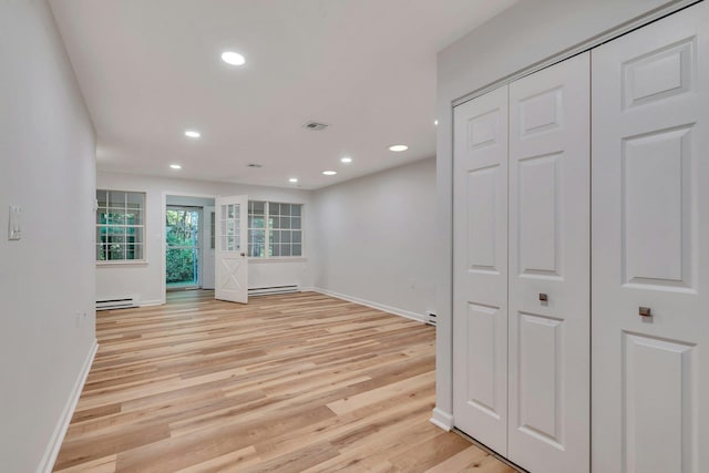 305C Torquay Court, Ridge, NY 11961 - unfurnished room with a baseboard radiator, light wood finished floors, and recessed lighting