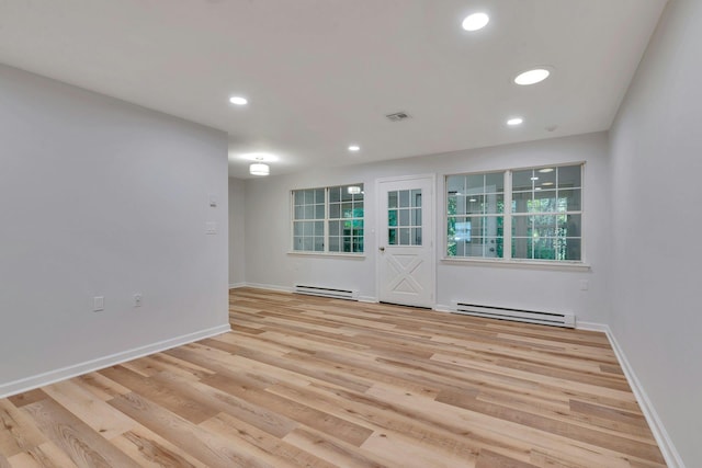 305C Torquay Court, Ridge, NY 11961 - empty room featuring a baseboard heating unit, recessed lighting, and wood finished floors