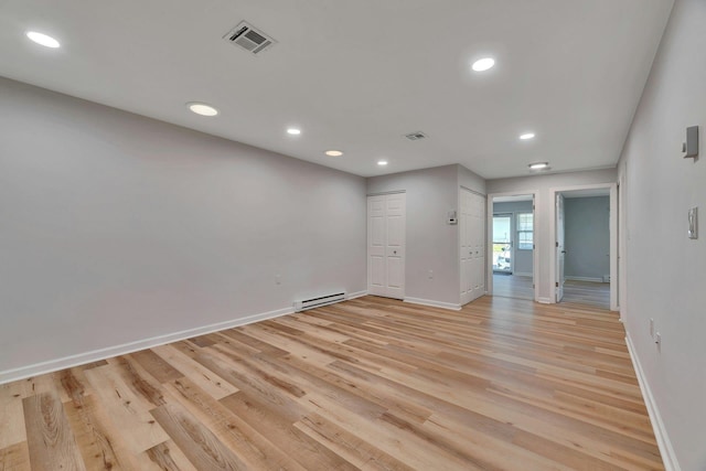 305C Torquay Court, Ridge, NY 11961 - empty room with a baseboard radiator, recessed lighting, and light wood-style floors