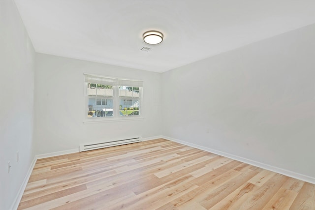 305C Torquay Court, Ridge, NY 11961 - spare room featuring baseboard heating and wood finished floors