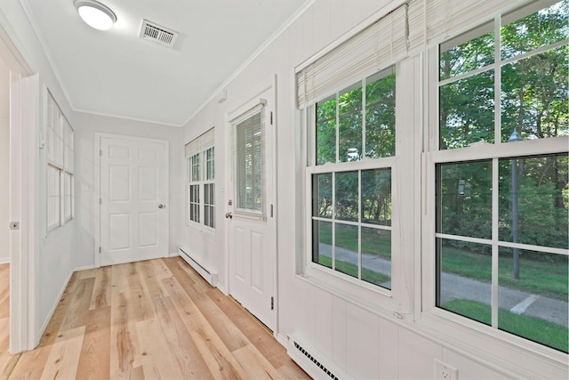 305C Torquay Court, Ridge, NY 11961 - entryway featuring baseboard heating, ornamental molding, and light wood-type flooring