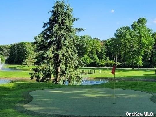 305C Torquay Court, Ridge, NY 11961 - surrounding community featuring a lawn, a putting green, a water view, and view of golf course
