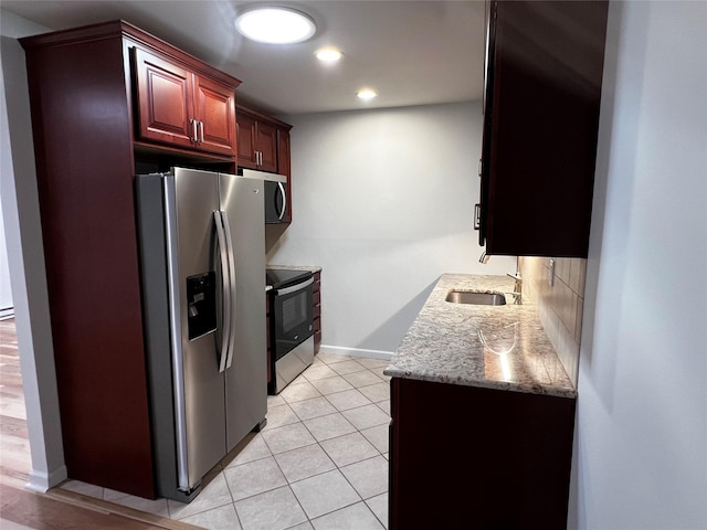 305C Torquay Court, Ridge, NY 11961 - kitchen with appliances with stainless steel finishes, recessed lighting, light stone counters, light tile patterned flooring, and backsplash