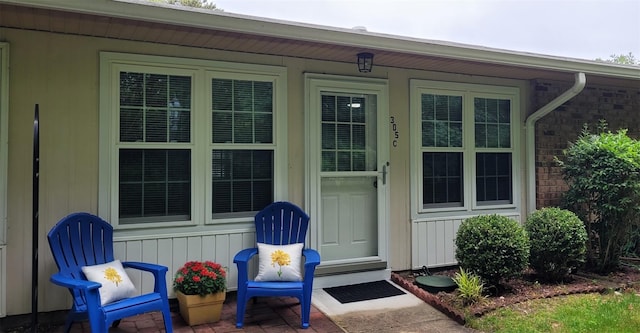 305C Torquay Court, Ridge, NY 11961 - view of exterior entry featuring brick siding