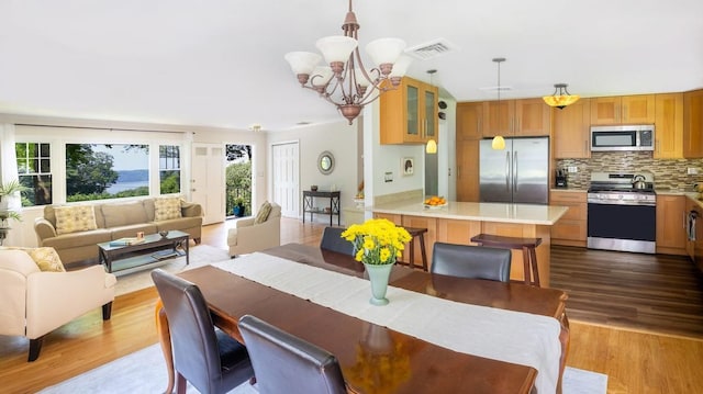 15 Rayson Ln, Dobbs Ferry, NY 10522 - dining area featuring a chandelier and wood finished floors