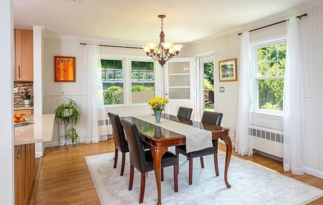 15 Rayson Ln, Dobbs Ferry, NY 10522 - dining room with radiator heating unit, a chandelier, healthy amount of natural light, crown molding, and a decorative wall