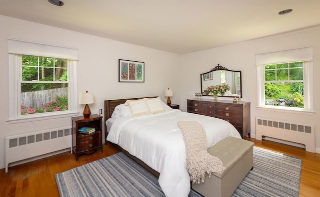 15 Rayson Ln, Dobbs Ferry, NY 10522 - bedroom with radiator, multiple windows, wood finished floors, and crown molding