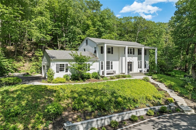 1508 Laurel Hollow Rd, Laurel Hollow, NY 11791 - greek revival house with a shingled roof and a view of trees