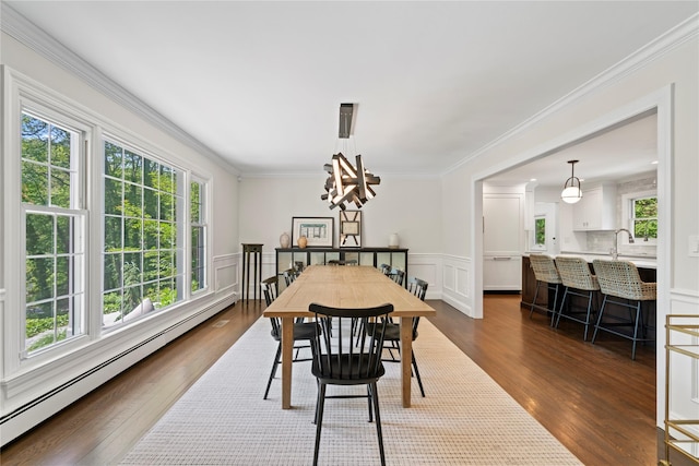 1508 Laurel Hollow Rd, Laurel Hollow, NY 11791 - dining space featuring a baseboard heating unit, plenty of natural light, dark wood finished floors, crown molding, and a chandelier