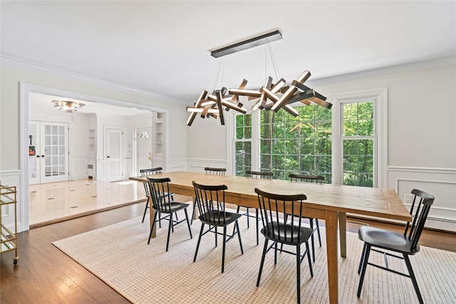 1508 Laurel Hollow Rd, Laurel Hollow, NY 11791 - dining room with crown molding, a decorative wall, wainscoting, wood finished floors, and french doors