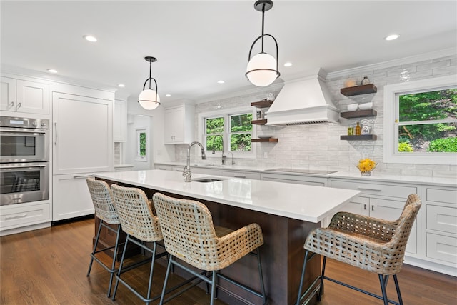 1508 Laurel Hollow Rd, Laurel Hollow, NY 11791 - kitchen with open shelves, stainless steel double oven, black electric cooktop, light countertops, and backsplash