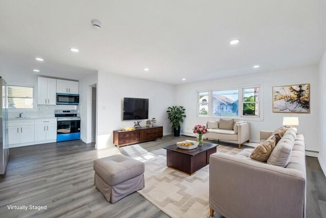 7 Argyle Dr, Shirley, NY 11967 - living area with light wood-type flooring, healthy amount of natural light, recessed lighting, and baseboard heating
