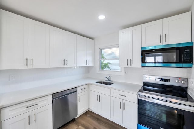 7 Argyle Dr, Shirley, NY 11967 - kitchen featuring stainless steel appliances, dark wood-type flooring, white cabinetry, light countertops, and recessed lighting