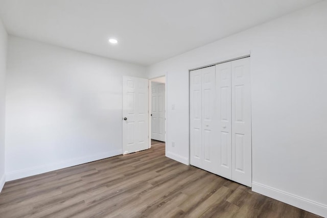 7 Argyle Dr, Shirley, NY 11967 - unfurnished bedroom featuring wood finished floors, recessed lighting, and a closet