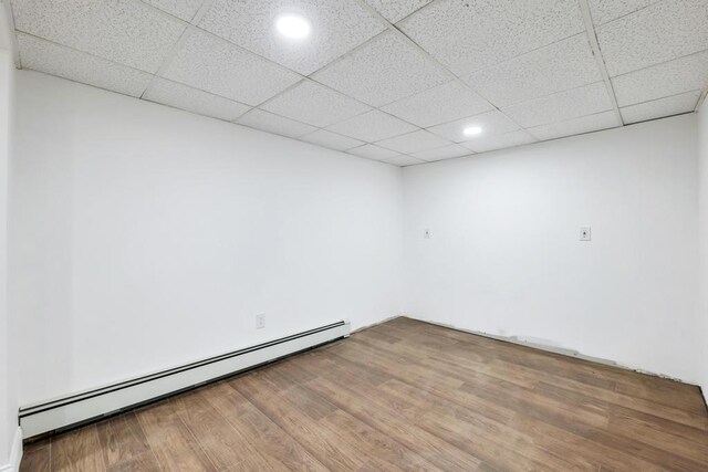 7 Argyle Dr, Shirley, NY 11967 - unfurnished room with baseboard heating, wood finished floors, recessed lighting, and a paneled ceiling