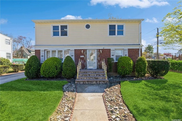 1377 D St, Elmont, NY 11003 - view of front of property featuring a front yard and brick siding
