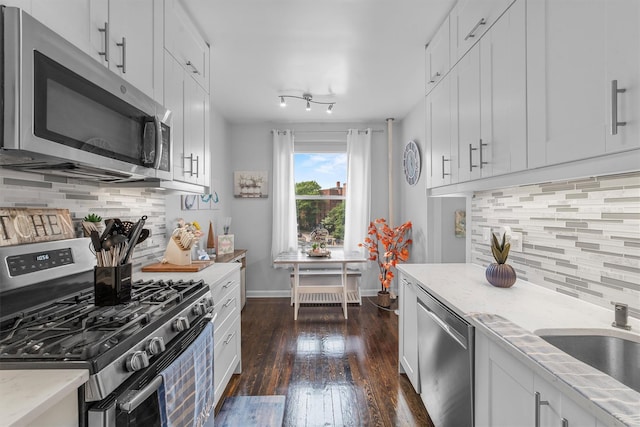 472 Gramatan Ave Unit Dd3, Mount Vernon, NY 10552 - kitchen featuring stainless steel appliances, dark wood-style flooring, decorative backsplash, white cabinetry, and light stone countertops